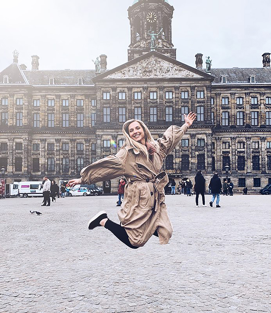 Photo of a female student jumping while studying abroad in Amsterdam