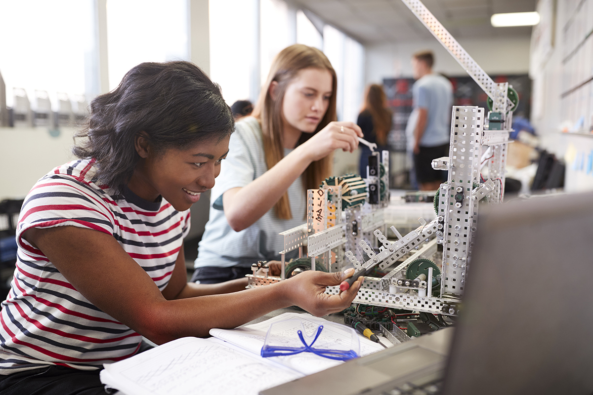 two female students working on a robotics for engineering course