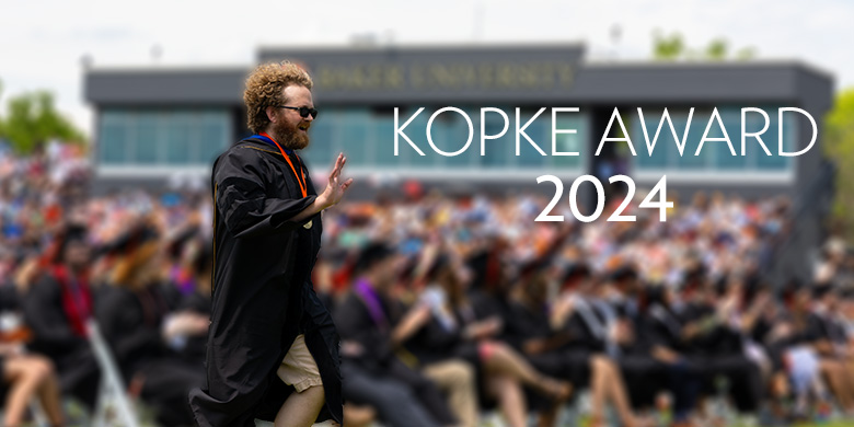Jamin Perry walking up to receive Kopke award at commencement