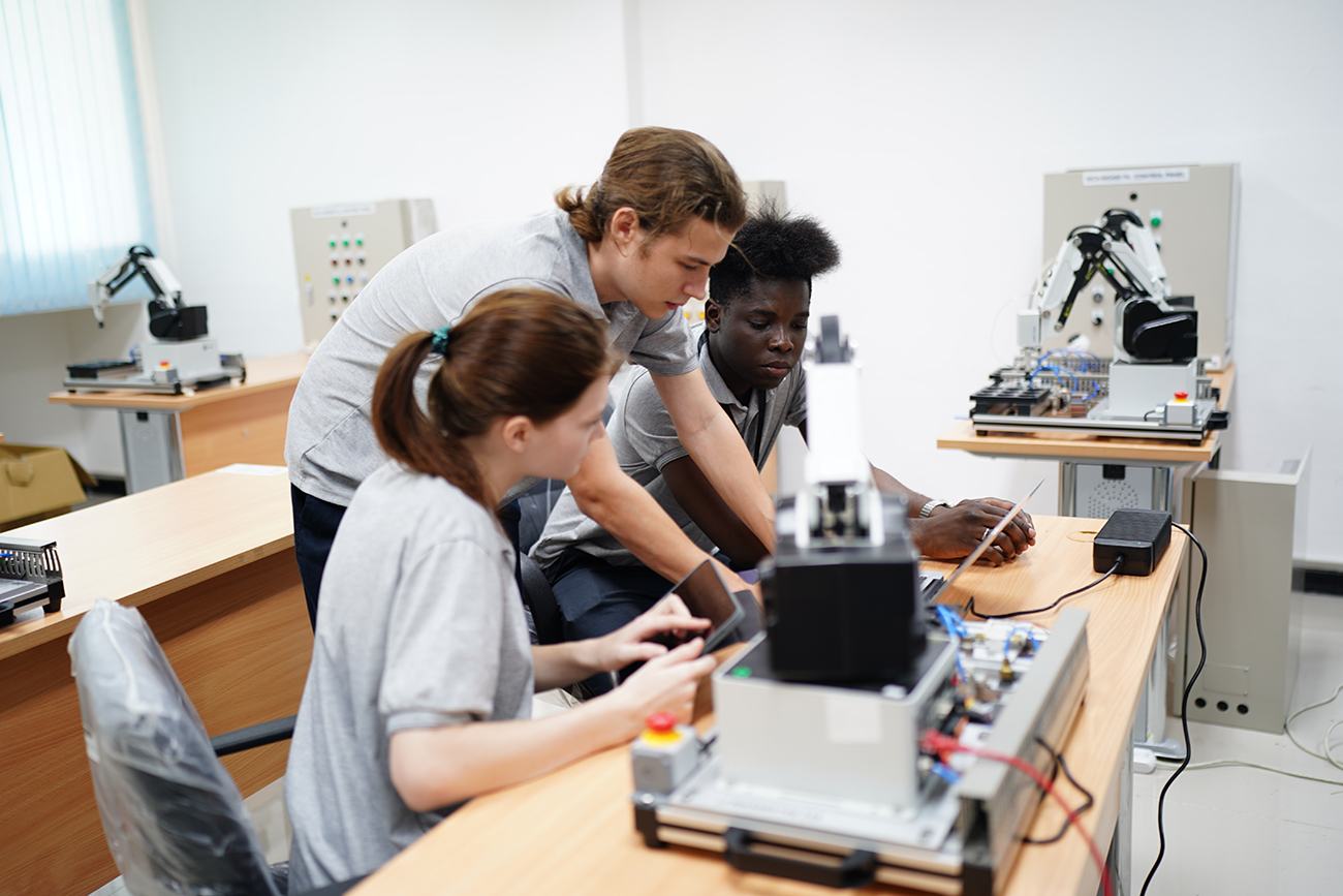 students working on robotic arm