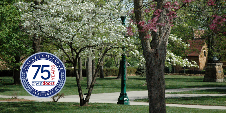 Flowering trees on campus and Open Door 75 badge